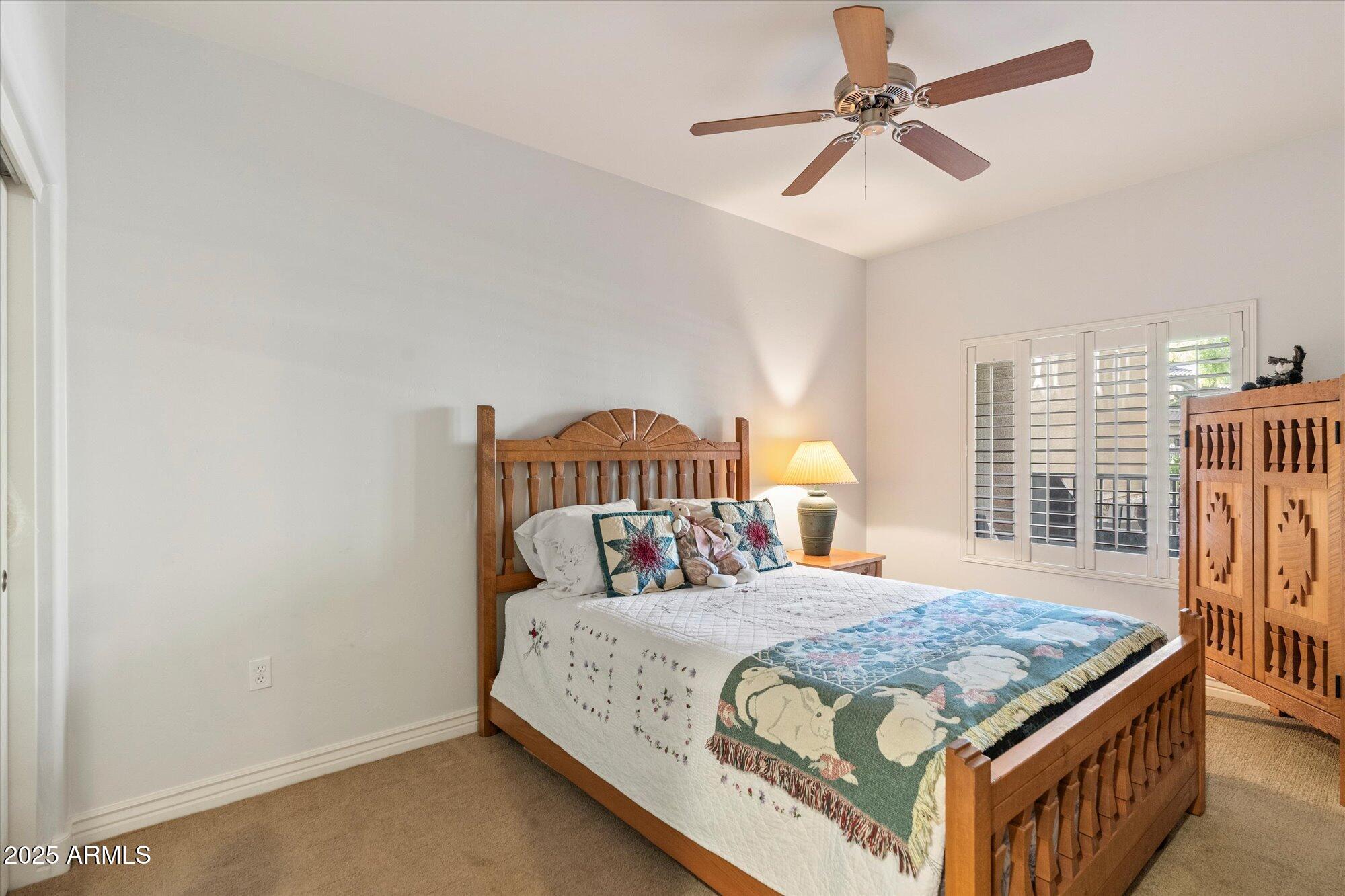 5350 East Deer Valley Drive, Unit 1238 Phoenix, AZ 85054 - Photo 18 of 29 a bedroom with a bed a dresser and window