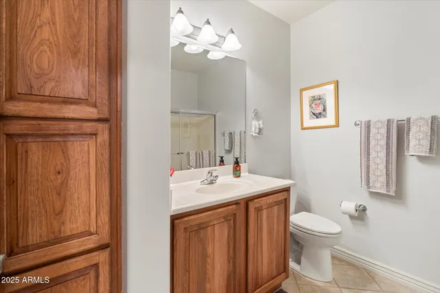 a bedroom with a bed a dresser and window