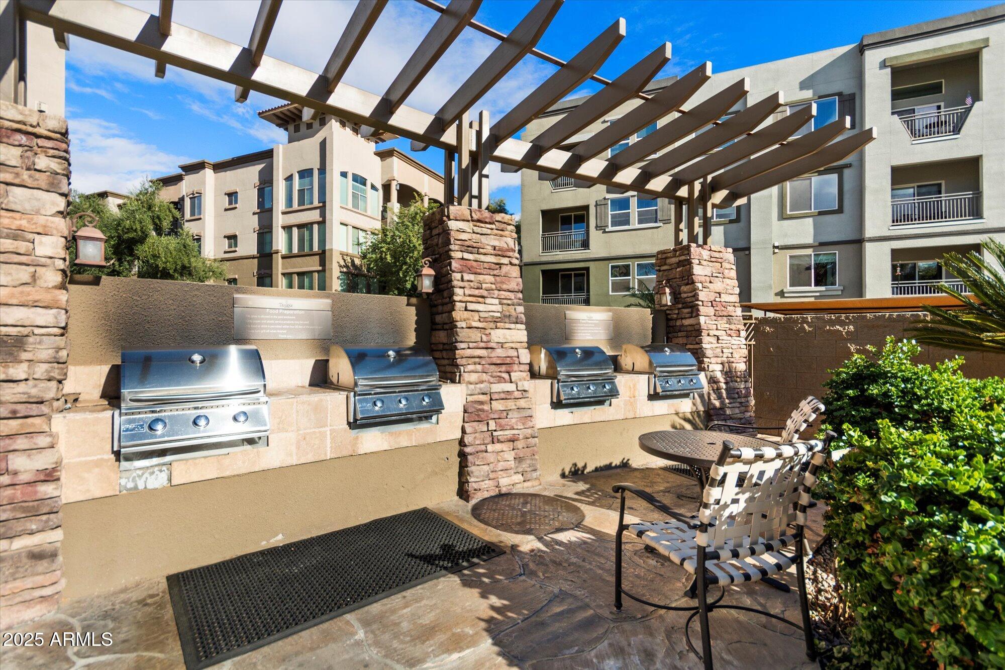 5350 East Deer Valley Drive, Unit 1238 Phoenix, AZ 85054 - Photo 25 of 29 a building outdoor space with patio furniture and potted plants