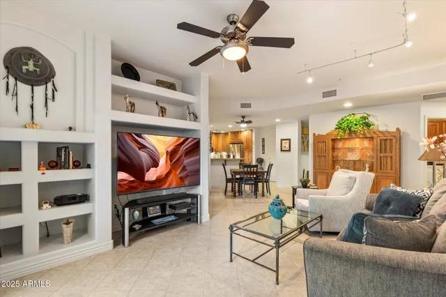 a living room with furniture a window and a flat screen tv