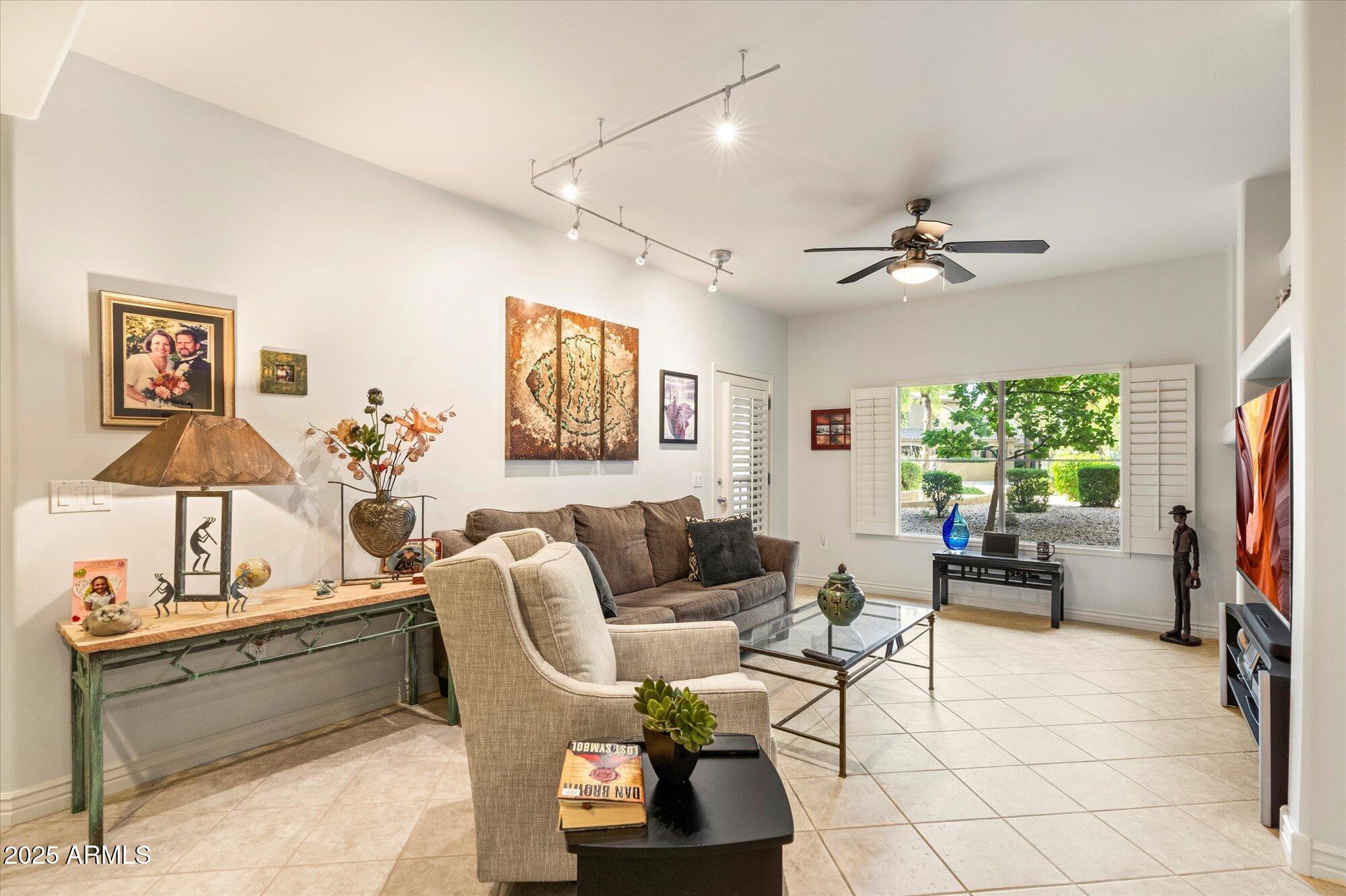 5350 East Deer Valley Drive, Unit 1238 Phoenix, AZ 85054 - Photo 9 of 29 a living room with furniture a chandelier and a flat screen tv