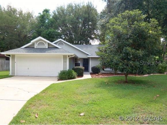 1113 Southwest 80th Terrace Gainesville, FL 32607 - Photo 1 of 1 a front view of a house with a garden
