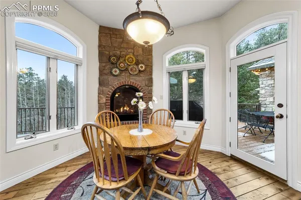 a dining room with furniture a chandelier and wooden floor