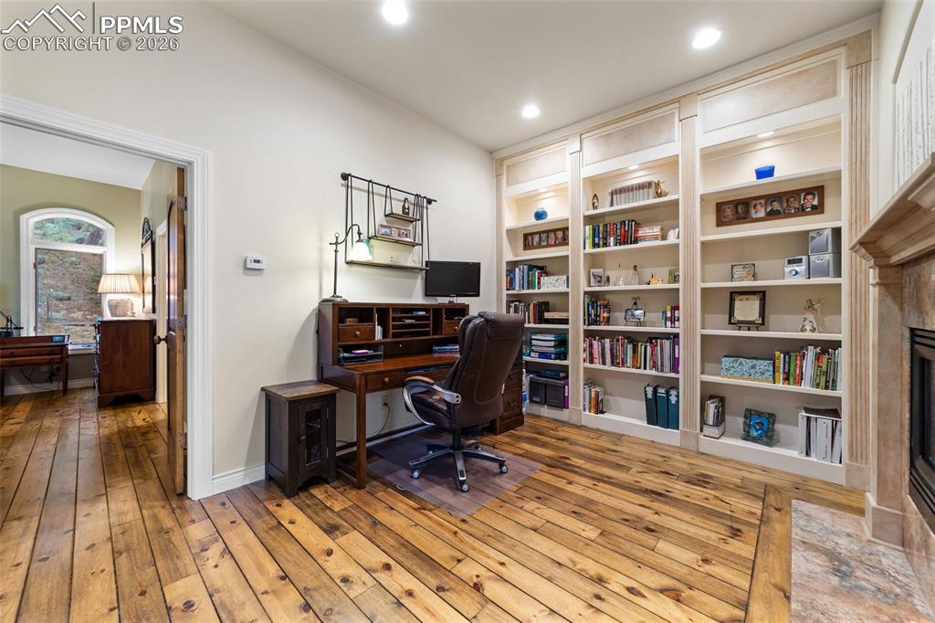 4450 Abert Ridge View Colorado Springs, CO 80908 - Photo 19 of 50 a view of a workspace with furniture and wooden floor