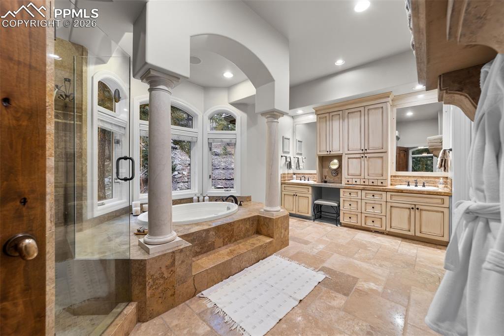 4450 Abert Ridge View Colorado Springs, CO 80908 - Photo 22 of 50 a large white kitchen with lots of counter space and stainless steel appliances