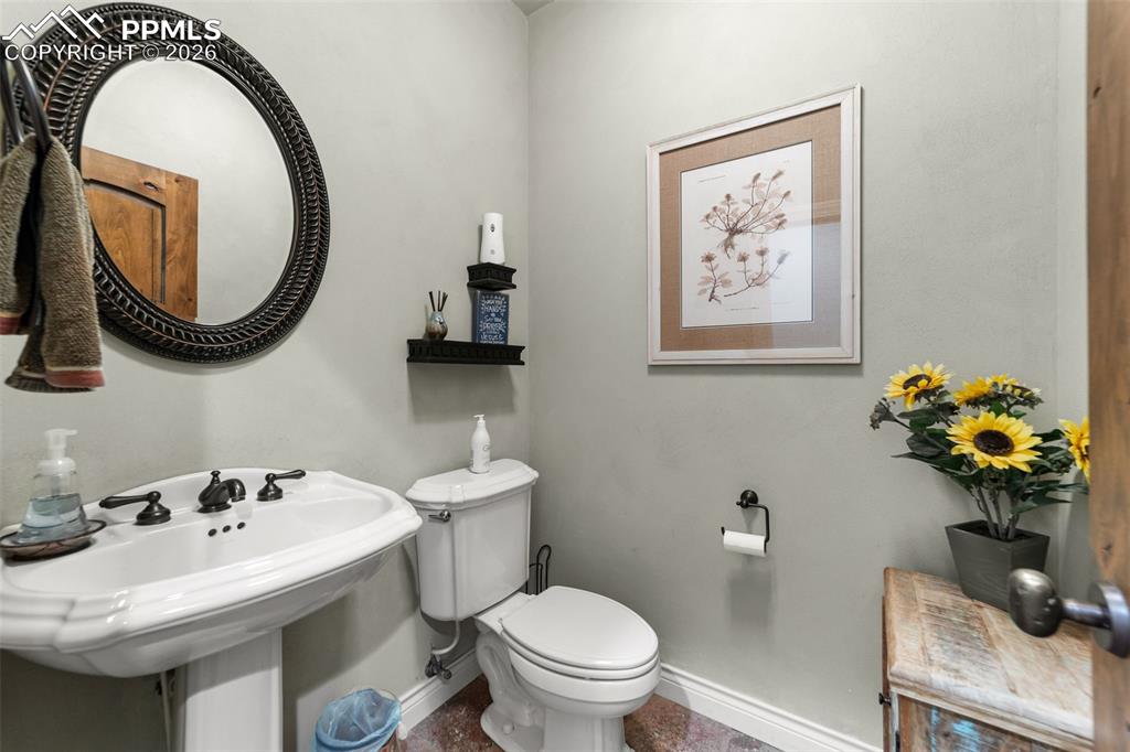 4450 Abert Ridge View Colorado Springs, CO 80908 - Photo 27 of 50 a bathroom with a toilet a sink and a mirror