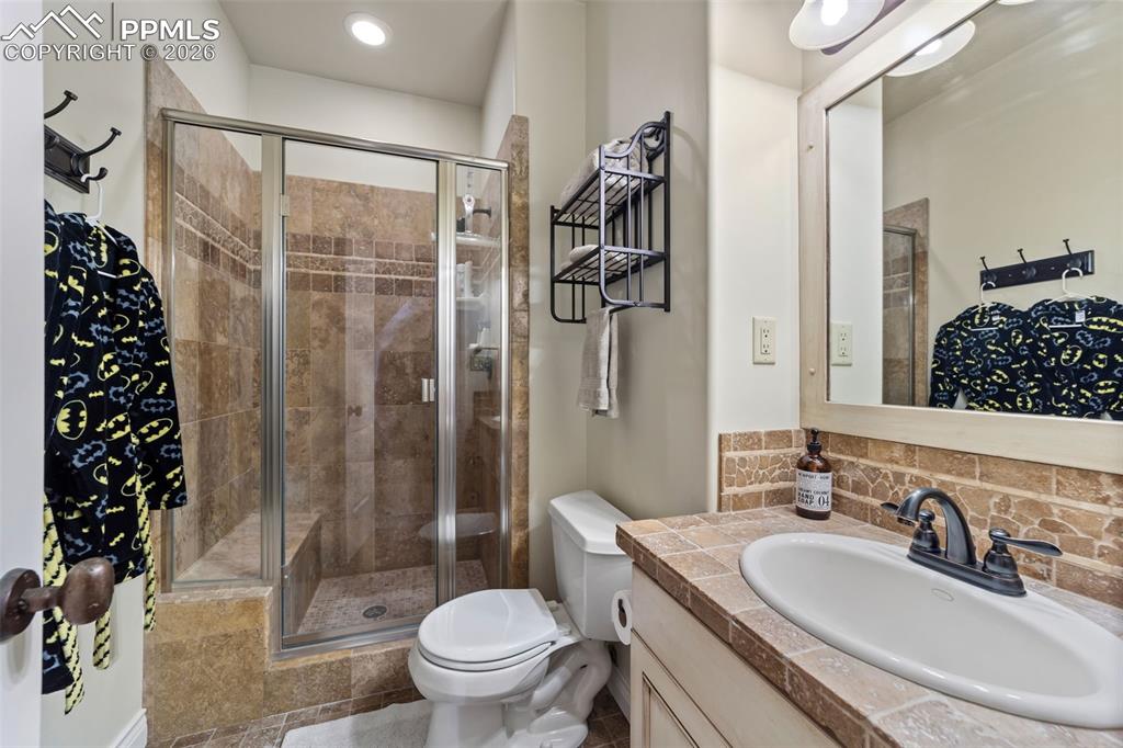 4450 Abert Ridge View Colorado Springs, CO 80908 - Photo 31 of 50 a bathroom with a sink toilet and shower