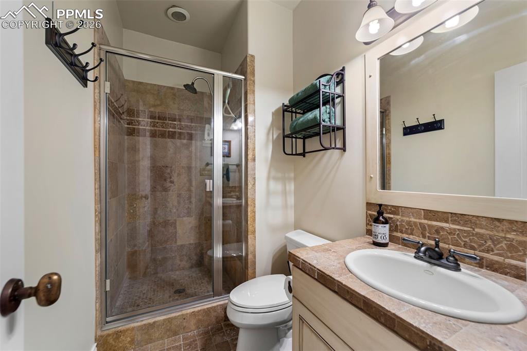 4450 Abert Ridge View Colorado Springs, CO 80908 - Photo 33 of 50 a bathroom with a sink a toilet and shower
