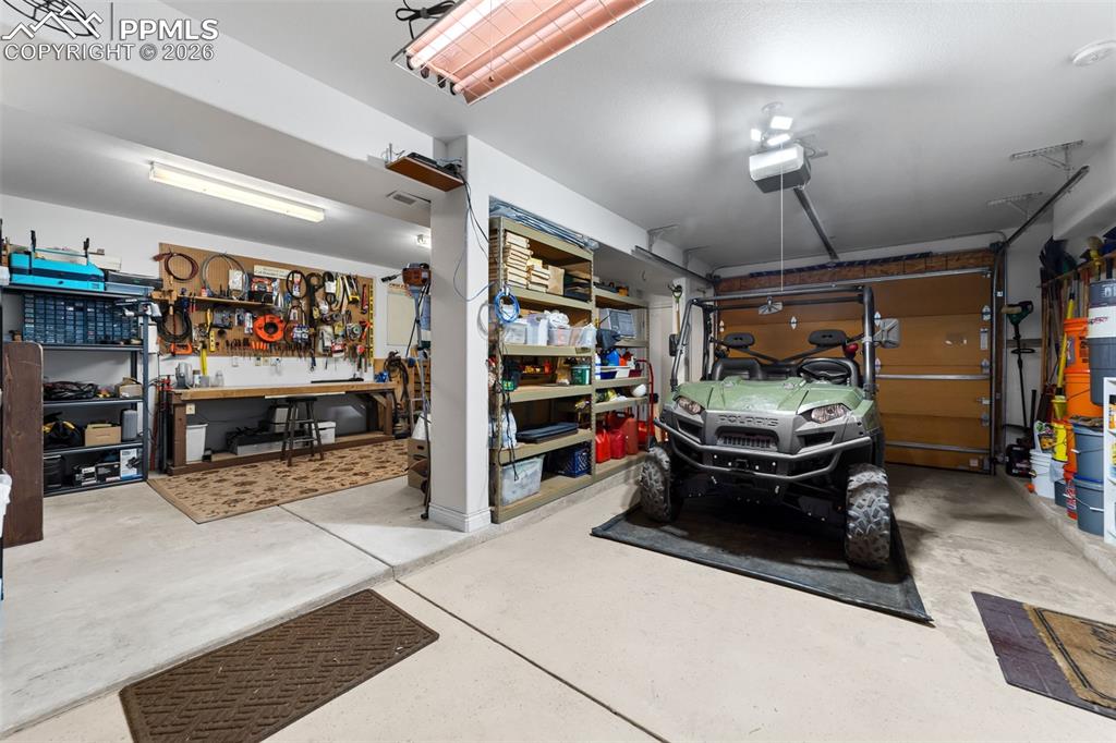 4450 Abert Ridge View Colorado Springs, CO 80908 - Photo 43 of 50 a view of parking garage with cars and a ceiling fan
