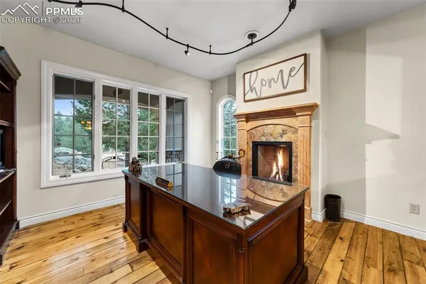 a living room with stainless steel appliances granite countertop furniture and a fireplace
