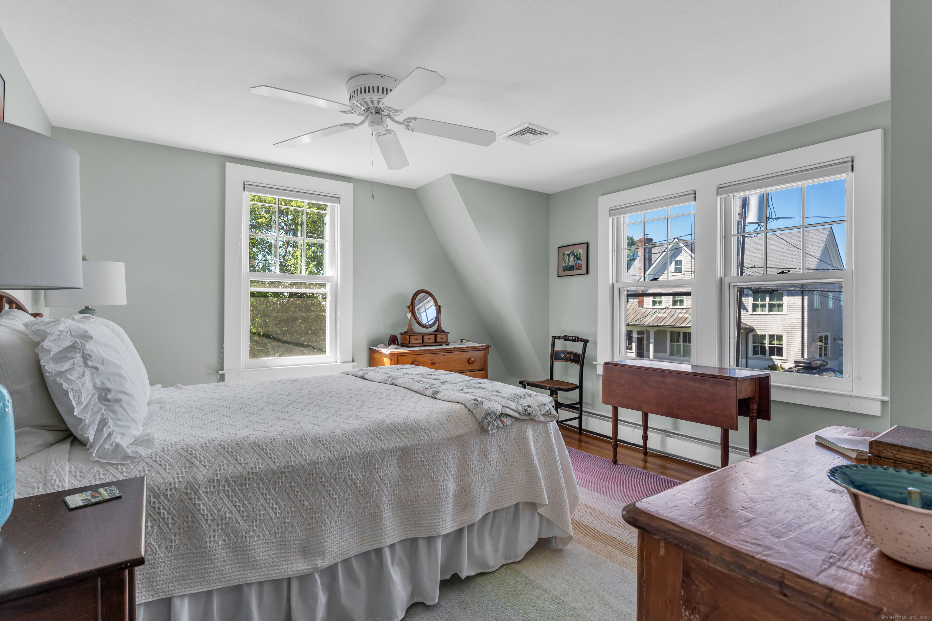 27 Ridgewood Avenue Madison, CT 06443 - Photo 11 of 31 a bedroom with a bed and wooden floor