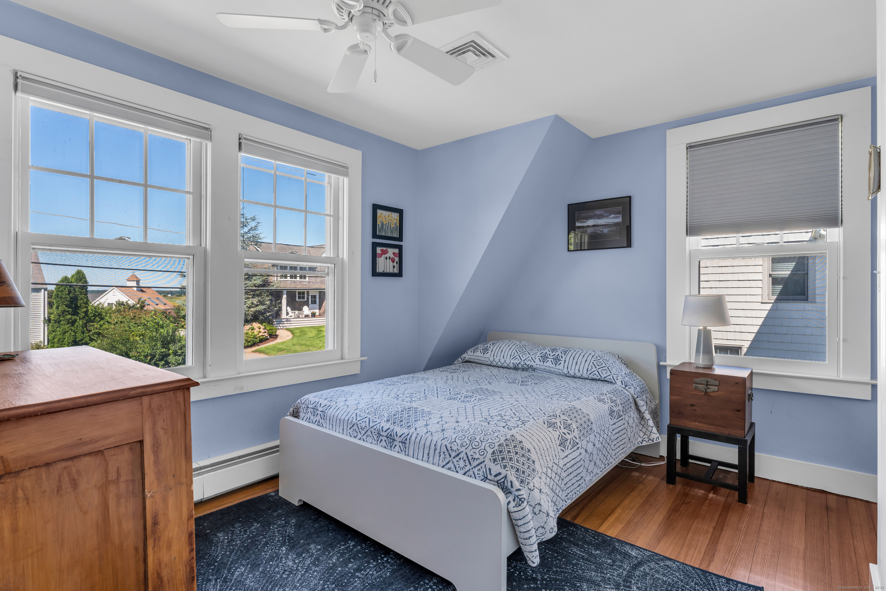 27 Ridgewood Avenue Madison, CT 06443 - Photo 15 of 31 a bedroom with a bed and a table in it