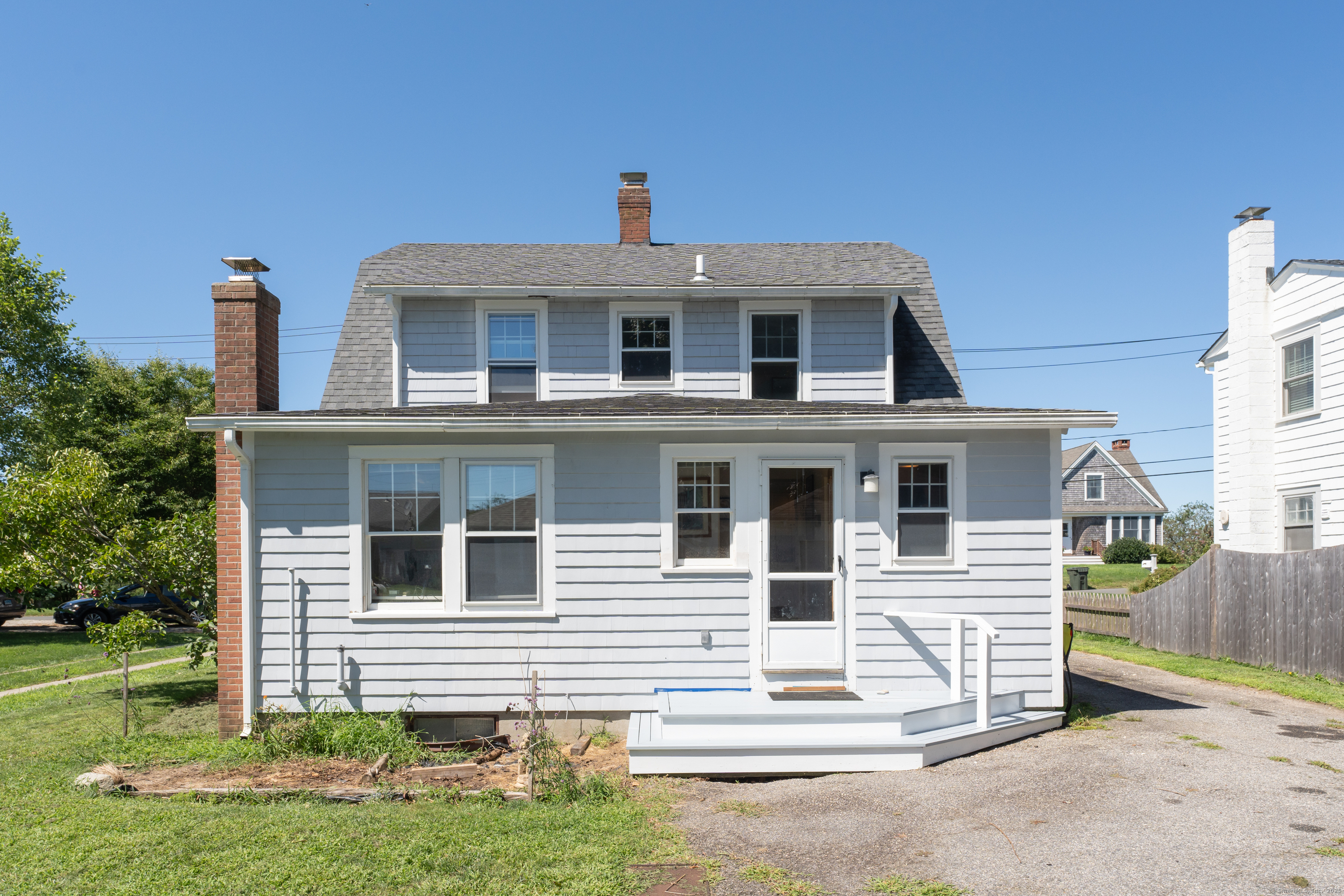 27 Ridgewood Avenue Madison, CT 06443 - Photo 21 of 31 a front view of a house with a yard