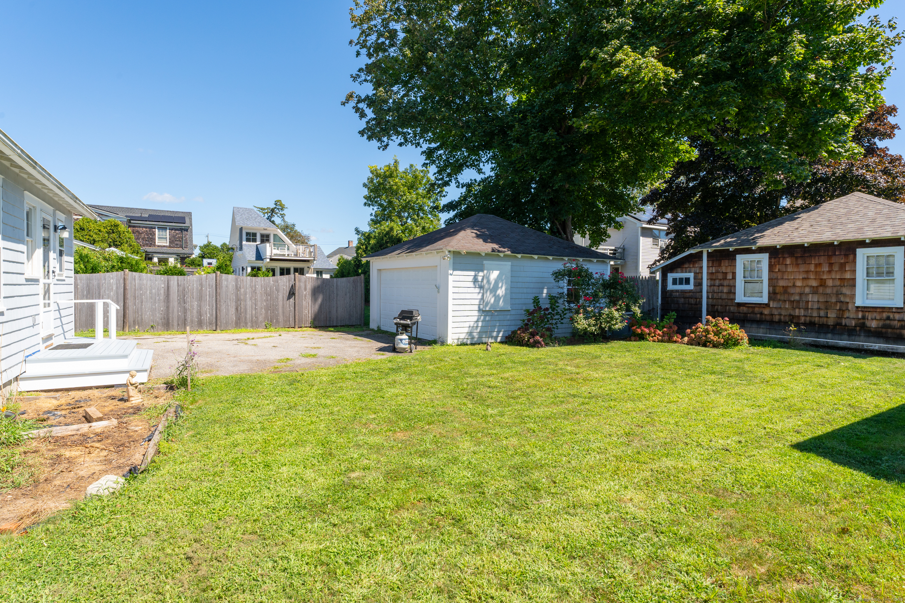 27 Ridgewood Avenue Madison, CT 06443 - Photo 23 of 31 a view of a house with a yard and a large tree