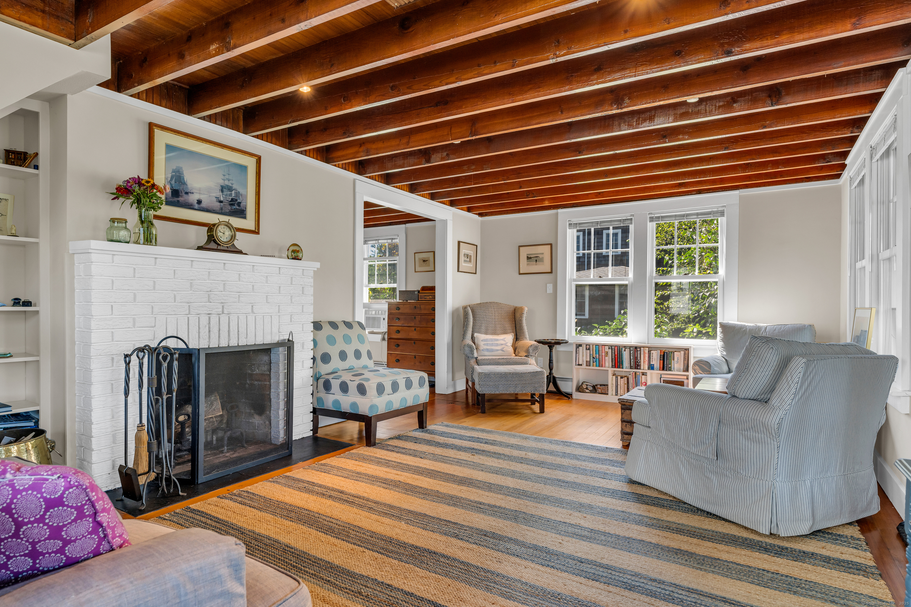 27 Ridgewood Avenue Madison, CT 06443 - Photo 30 of 31 a living room with furniture and a fireplace