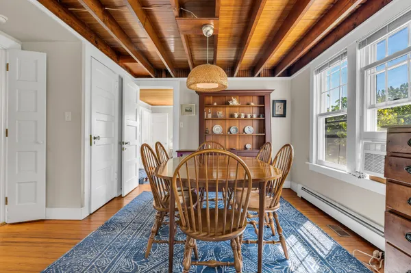 a view of a dining room with furniture window and wooden floor