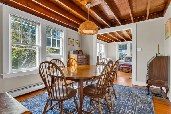 a view of a dining room with furniture window and wooden floor