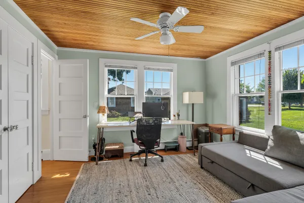 a living room with furniture and a wooden floor