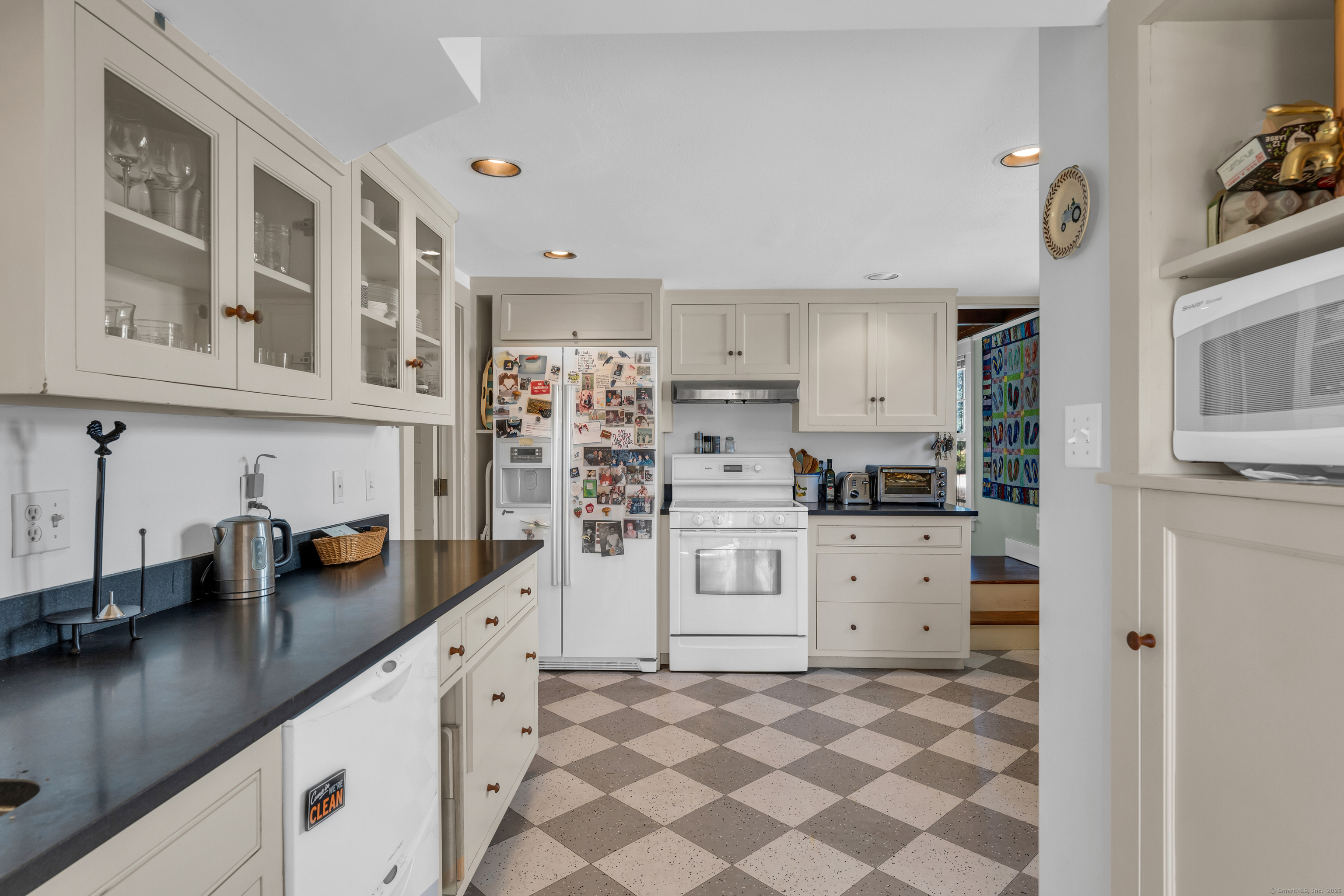 27 Ridgewood Avenue Madison, CT 06443 - Photo 8 of 31 a kitchen with white cabinets and appliances