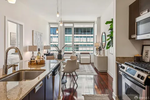 a kitchen with granite countertop a sink and a stove top oven