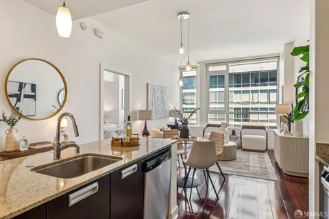 a kitchen with a sink and living room