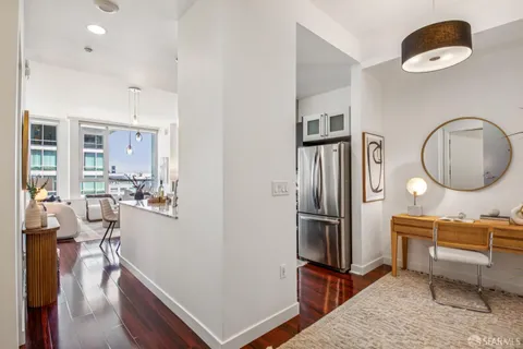 a living room with furniture and a mirror