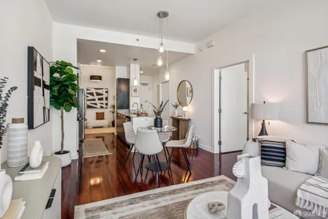 a view of a dining room with furniture and wooden floor