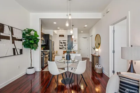 a view of a dining room with furniture and wooden floor