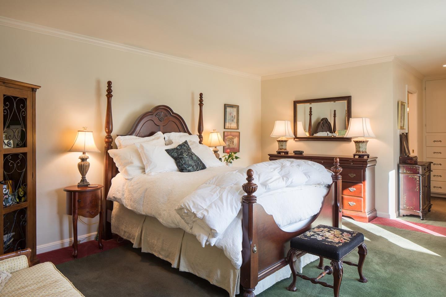 4117 Sunridge Road Pebble Beach, CA 93953 - Photo 14 of 30 a bed room with a bed chair and a window