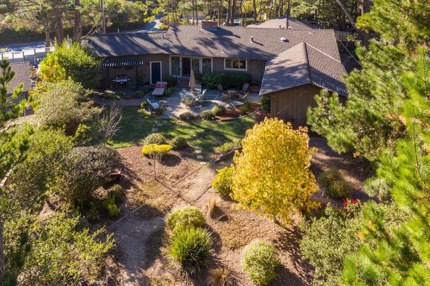 4117 Sunridge Road Pebble Beach, CA 93953 - Photo 25 of 30 a aerial view of a house with swimming pool and large trees