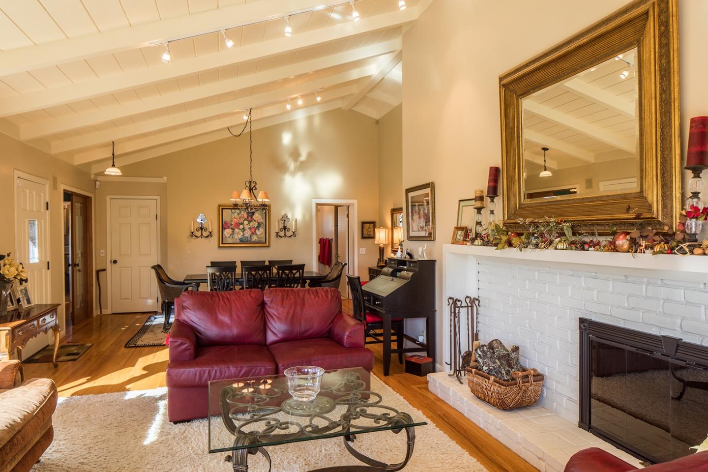 4117 Sunridge Road Pebble Beach, CA 93953 - Photo 6 of 30 a living room with furniture a fireplace and a floor to ceiling window