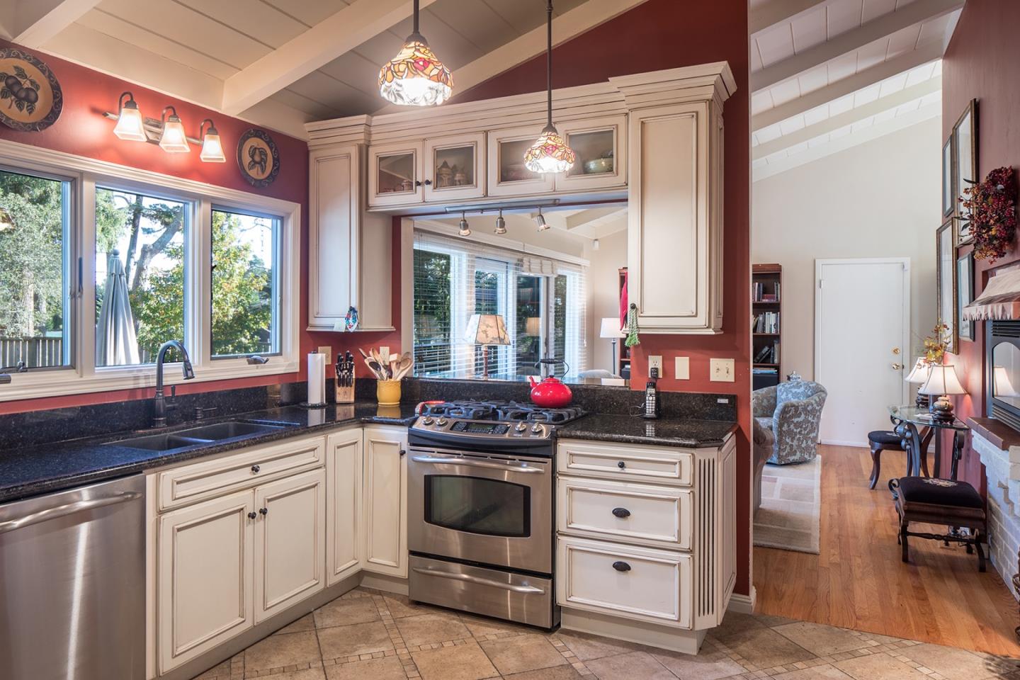 4117 Sunridge Road Pebble Beach, CA 93953 - Photo 9 of 30 a kitchen with stainless steel appliances a stove oven and a large window