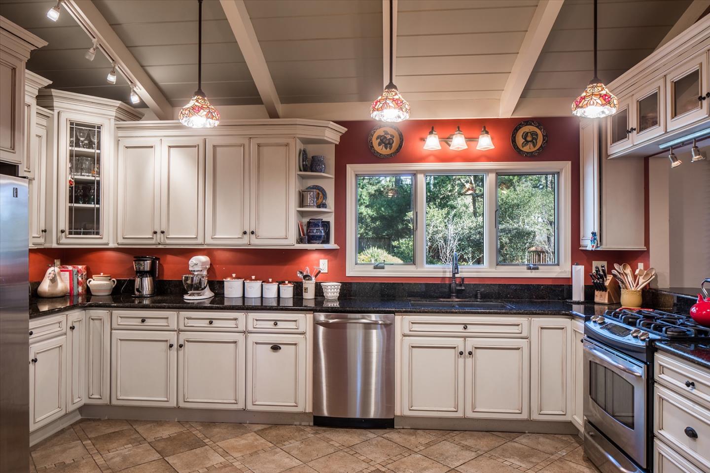 4117 Sunridge Road Pebble Beach, CA 93953 - Photo 10 of 30 a kitchen with stainless steel appliances granite countertop a sink and a stove