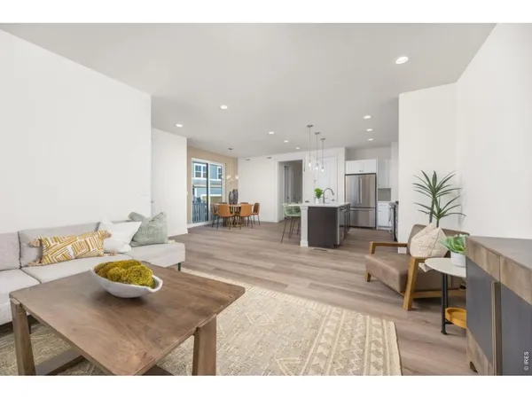 a living room with furniture and kitchen view