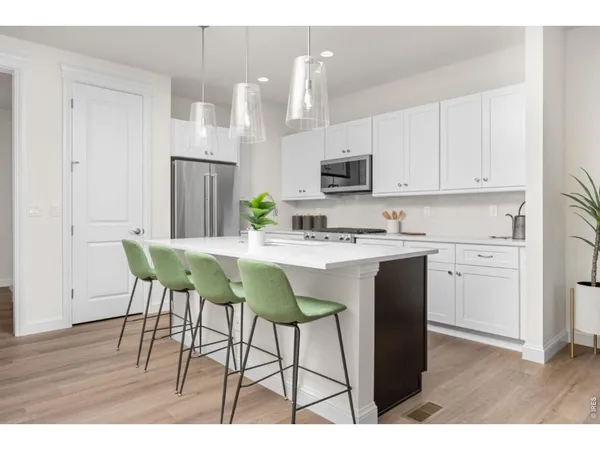 a kitchen with kitchen island white cabinets appliances and cabinets
