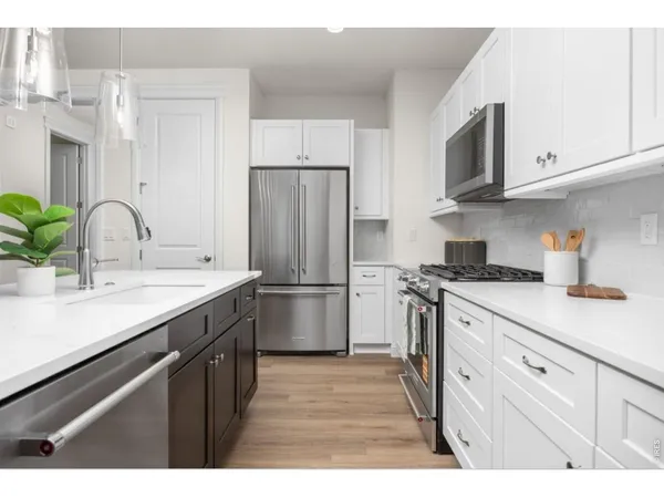 a kitchen with stainless steel appliances a sink cabinets and a counter top space