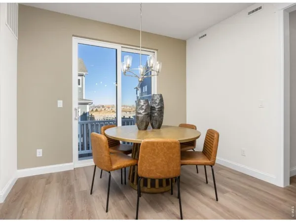 a dining room with furniture and wooden floor