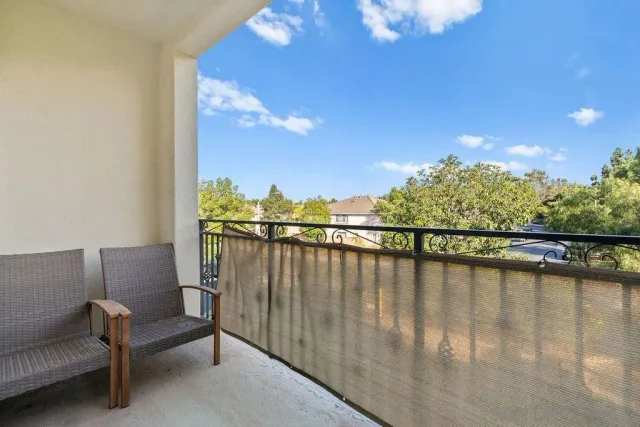 a balcony with outdoor seating and water view