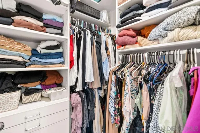 a room with a bed and a large window