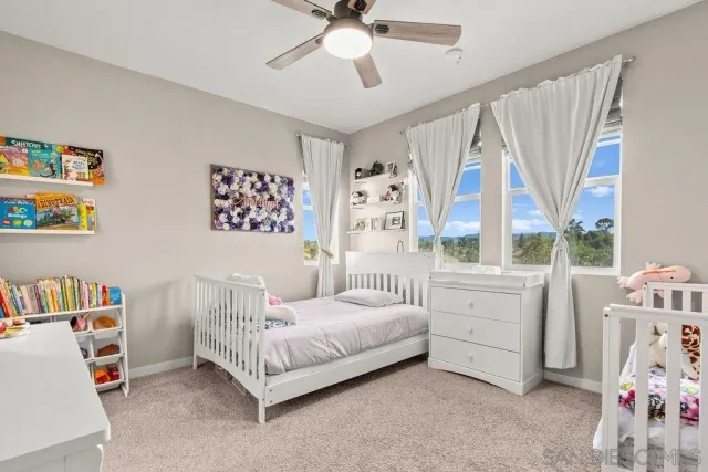 a bedroom with furniture and a flat screen tv