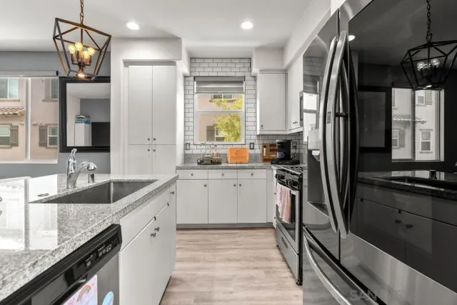 a kitchen with a refrigerator sink and stove