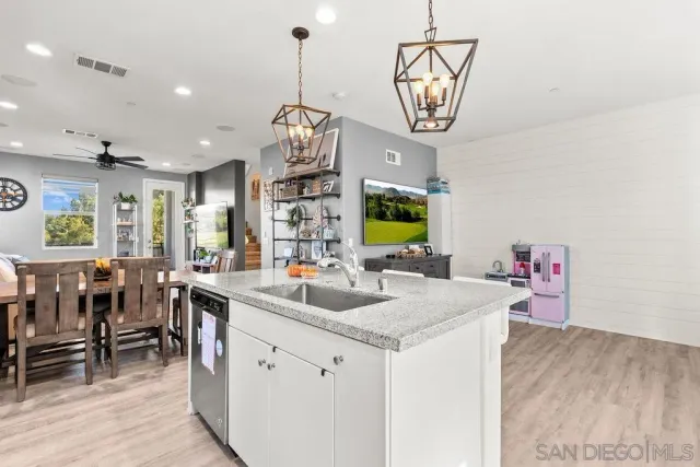 a view of kitchen island with center island wooden floor cabinets and windows