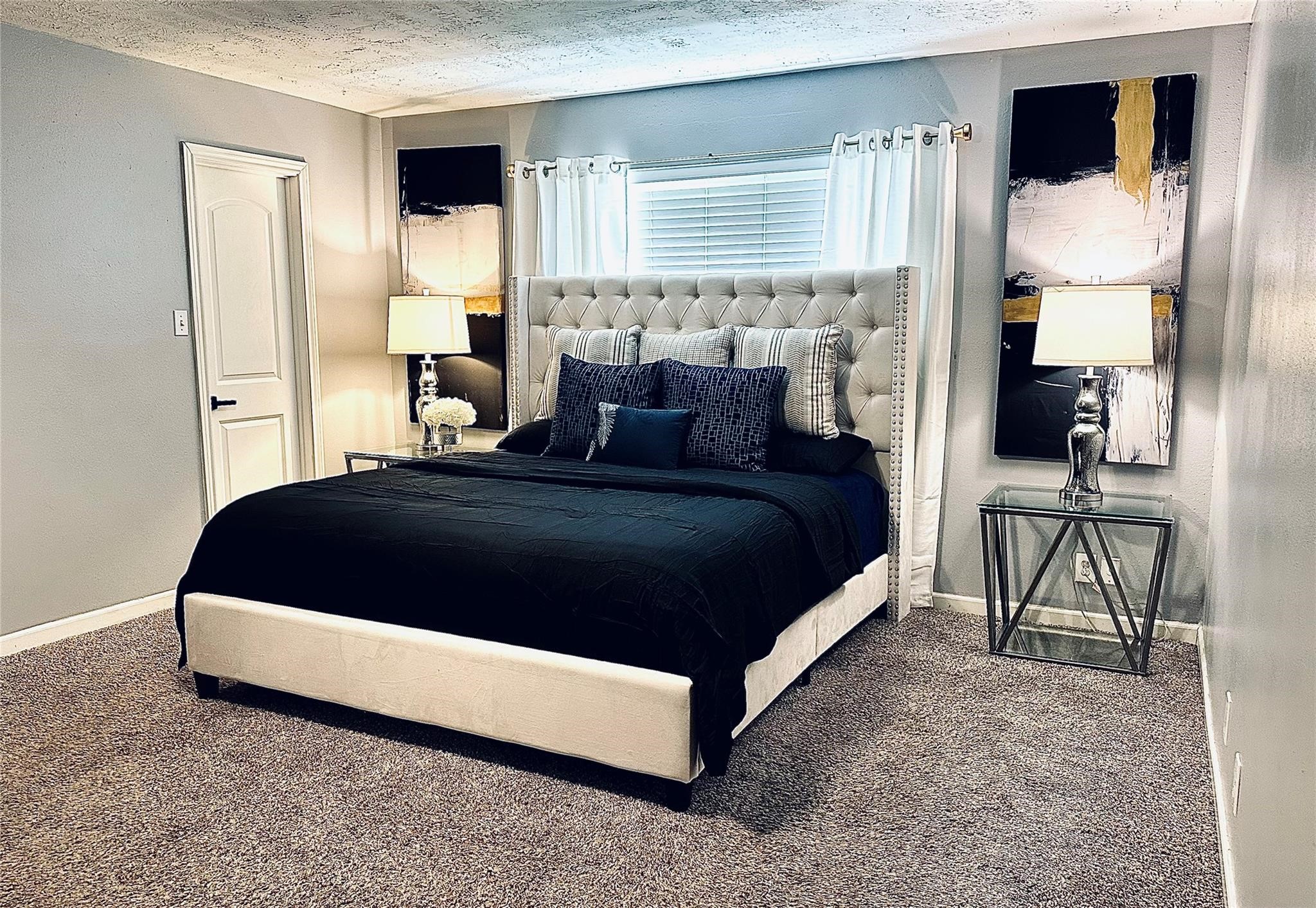 1457 Camellia Street Sweeny, TX 77480 - Photo 13 of 29 a spacious bedroom with a bed a lamp and a large window