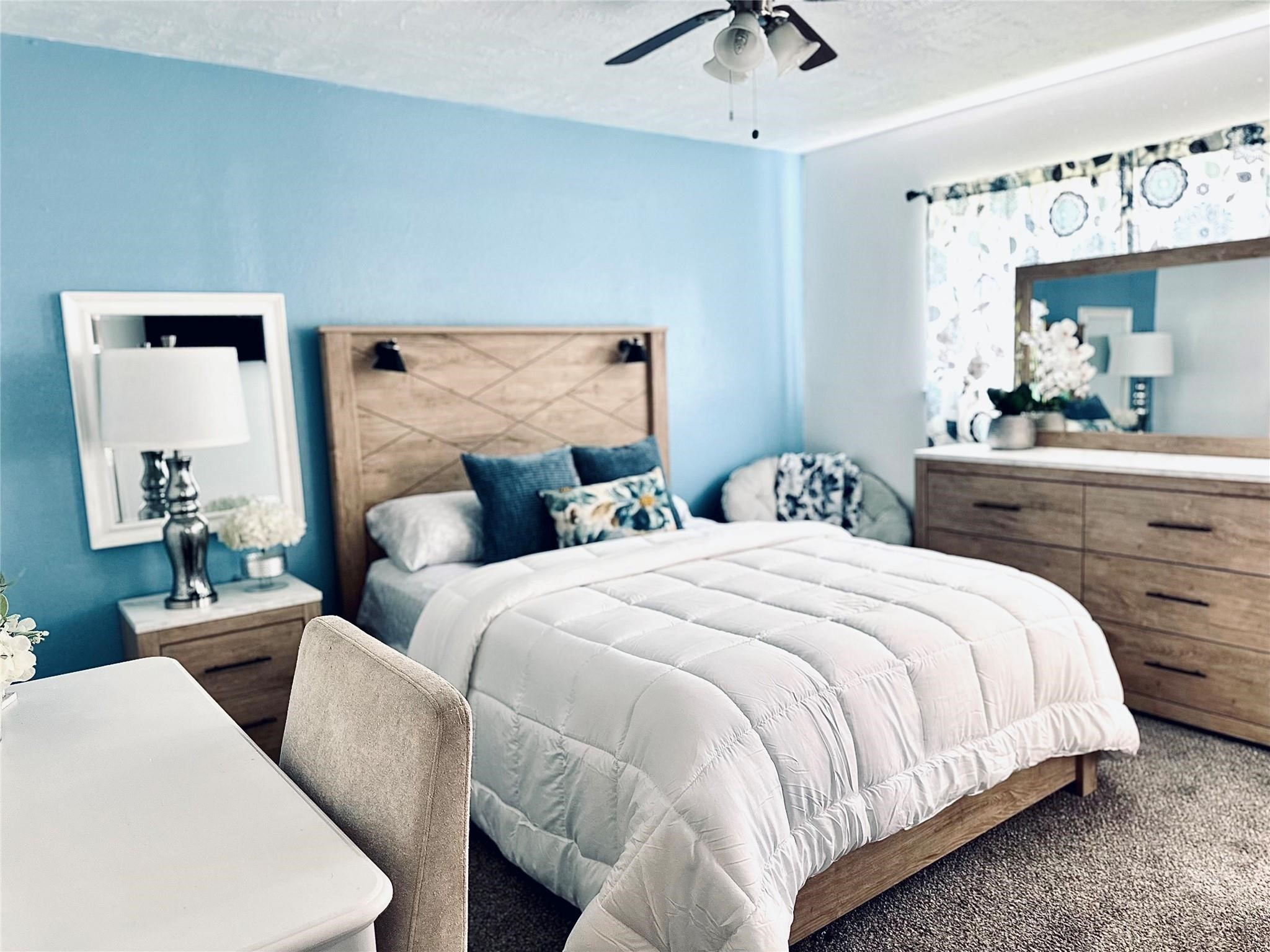 1457 Camellia Street Sweeny, TX 77480 - Photo 18 of 29 a bedroom with bed and a chandelier