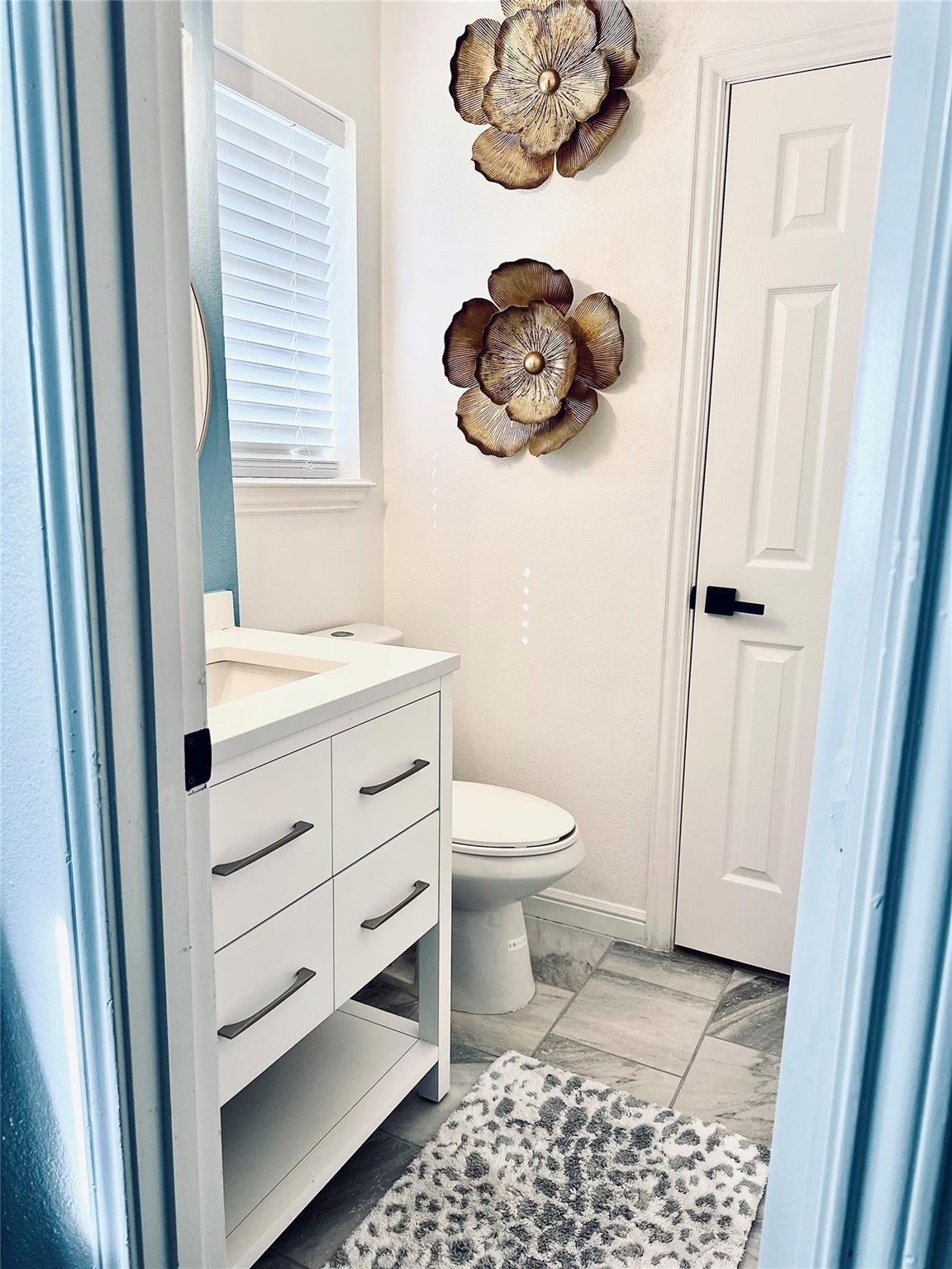 1457 Camellia Street Sweeny, TX 77480 - Photo 21 of 29 a bathroom with a toilet a sink and vanity