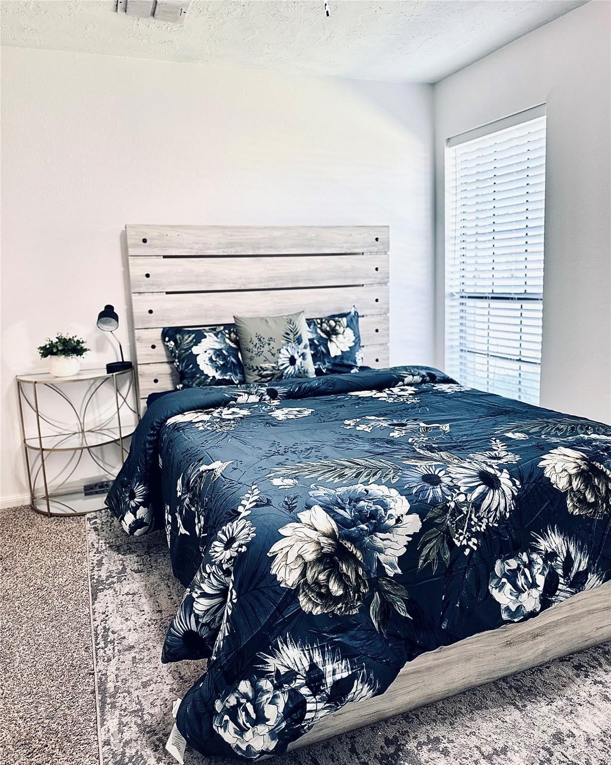 1457 Camellia Street Sweeny, TX 77480 - Photo 25 of 29 a bed sitting in a bedroom next to a window and dresser