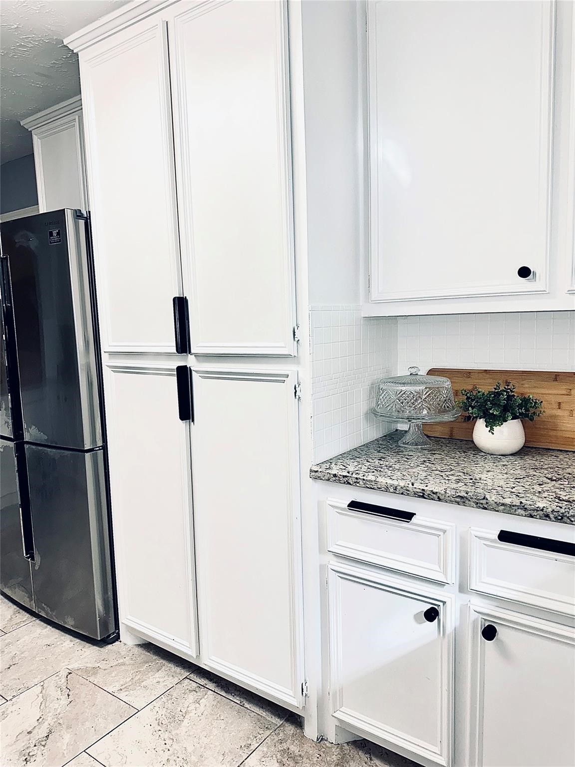 1457 Camellia Street Sweeny, TX 77480 - Photo 10 of 29 a kitchen with granite countertop a refrigerator and a sink