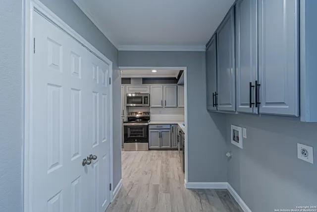a kitchen with cabinets and a stove