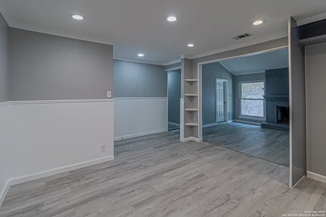 an empty room with wooden floor and closet