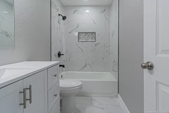 a bathroom with a toilet sink and shower